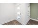 Bright entryway with stylish door with windows, wood-look flooring, and fresh white paint at 3935 Willow Gate Way, Knightdale, NC 27604