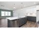 Open kitchen with a large island, stainless appliances, and wood-look flooring at 3935 Willow Gate Way, Knightdale, NC 27604
