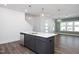 Modern kitchen island featuring white countertops, gray cabinets, and stainless steel appliances offers seating at 3935 Willow Gate Way, Knightdale, NC 27604
