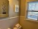 Small bathroom with beige tile and a window at 404 W Ninth St, Siler City, NC 27344