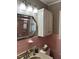 Pink tiled bathroom with a vanity and medicine cabinet at 404 W Ninth St, Siler City, NC 27344