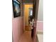Pink tiled bathroom with access to another room at 404 W Ninth St, Siler City, NC 27344