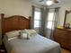 Bedroom with wooden bed frame and gray bedding at 404 W Ninth St, Siler City, NC 27344