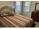 Bright bedroom with striped bedding and wood dresser at 404 W Ninth St, Siler City, NC 27344