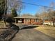 Brick ranch house with carport and long driveway at 404 W Ninth St, Siler City, NC 27344