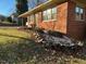 Brick ranch house with a stone retaining wall at 404 W Ninth St, Siler City, NC 27344