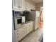 Kitchen with white cabinets, appliances, and tile floor at 404 W Ninth St, Siler City, NC 27344
