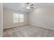 Bright, carpeted bedroom with natural light streaming through the window, offering a cozy and inviting space at 5302 River Reach Dr, Raleigh, NC 27616