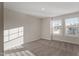 This bedroom features two large windows, neutral walls, and carpeted floors at 5302 River Reach Dr, Raleigh, NC 27616