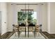Bright dining area with a modern light fixture, large window, and elegant decor perfect for gatherings at 5302 River Reach Dr, Raleigh, NC 27616