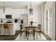 Well-lit dining area featuring a stylish table set, modern lighting, and seamless connection to the kitchen at 5302 River Reach Dr, Raleigh, NC 27616