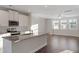 Open kitchen design featuring granite countertops, stainless appliances, and bright natural light at 5302 River Reach Dr, Raleigh, NC 27616