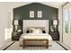 This main bedroom features a large bed, dark green accent wall, and carpeted floors at 5302 River Reach Dr, Raleigh, NC 27616