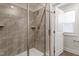 This is a full, tiled shower with glass doors and a showerhead at 5302 River Reach Dr, Raleigh, NC 27616