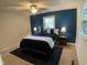 Bright bedroom with a queen bed and blue accent wall at 5321 Yardley Ter, Durham, NC 27707