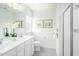 Bathroom with double vanity, frameless shower, and gray floor tiles at 600 Mohinda Way, Willow Springs, NC 27592
