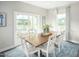 Bright dining room with wooden table, sliding glass door to deck at 600 Mohinda Way, Willow Springs, NC 27592