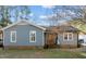 Ranch home features gray siding, a wood front door, and a landscaped yard at 6516 Battle Bridge Rd, Raleigh, NC 27610
