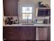 Modern kitchen with dark cabinets and white countertops at 6516 Battle Bridge Rd, Raleigh, NC 27610