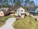 Aerial view of two-story home showcasing its traditional design, manicured lawn, and a welcoming front porch at 713 Heidelberg St, Durham, NC 27704
