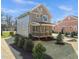 Backyard view showcasing the screened in porch, landscaping, and exterior features at 713 Heidelberg St, Durham, NC 27704