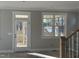 Unfinished living room featuring natural light, large windows, and access to the outdoors with a screen door at 713 Heidelberg St, Durham, NC 27704
