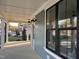 Inviting covered porch with dark exterior windows and ceiling fans at 715 Heidelberg St, Durham, NC 27704