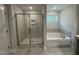 Bathroom featuring glass enclosed shower and large soaking tub at 752 Portland Rose Dr, Knightdale, NC 27545