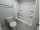 Bathroom featuring a tub and shower combo, toilet and towel rack at 752 Portland Rose Dr, Knightdale, NC 27545