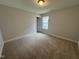 Bedroom with carpeted flooring, overhead lighting and a window at 752 Portland Rose Dr, Knightdale, NC 27545