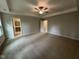 Bedroom featuring neutral colored carpet, ceiling fan, tray ceilings and en suite bathroom at 752 Portland Rose Dr, Knightdale, NC 27545