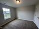 Bedroom featuring carpeted flooring, a window and overhead lighting at 752 Portland Rose Dr, Knightdale, NC 27545