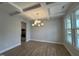 Bright dining room featuring hardwood floors, coffered ceilings and stylish light fixture at 752 Portland Rose Dr, Knightdale, NC 27545