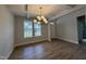 Bright dining room featuring hardwood floors, modern chandelier and abundant natural light at 752 Portland Rose Dr, Knightdale, NC 27545