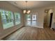 Bright dining area featuring hardwood floors and a back door leading to a patio at 752 Portland Rose Dr, Knightdale, NC 27545