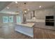 Stylish kitchen with granite island, stainless appliances, and modern pendant lighting at 752 Portland Rose Dr, Knightdale, NC 27545