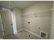 Functional laundry room with tile flooring and built-in shelving at 752 Portland Rose Dr, Knightdale, NC 27545