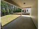 Covered patio with concrete flooring overlooks a lush green lawn and wooded area, seamlessly blending indoor/outdoor living at 752 Portland Rose Dr, Knightdale, NC 27545