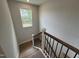 Stairway with wood and metal railings and large window at 752 Portland Rose Dr, Knightdale, NC 27545