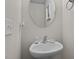 Small half bathroom with a pedestal sink and oval mirror at 810 Brake St, Nashville, NC 27856