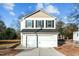 Two-story house with a white garage door and beige siding at 810 Brake St, Nashville, NC 27856