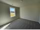 Bedroom with window and grey carpet at 83 Harvest Hills Ln, Dunn, NC 28334