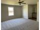 Spacious bedroom with ceiling fan and large window at 83 Harvest Hills Ln, Dunn, NC 28334