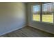 Bright bedroom with large window and wood-look flooring at 83 Harvest Hills Ln, Dunn, NC 28334