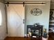 Entryway with white barn door and hardwood floors at 1002 Godwin Ln, Dunn, NC 28334