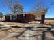 Brick ranch house with covered porch and side entry at 1002 Godwin Ln, Dunn, NC 28334