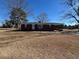Brick ranch house with covered porch and large yard at 1002 Godwin Ln, Dunn, NC 28334