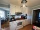 Charming kitchen with white cabinets and a modern range hood at 1002 Godwin Ln, Dunn, NC 28334