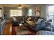 Living room with hardwood floors, sectional sofa, and large windows at 1002 Godwin Ln, Dunn, NC 28334