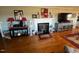 Living room with hardwood floors, fireplace, and large TV at 1002 Godwin Ln, Dunn, NC 28334